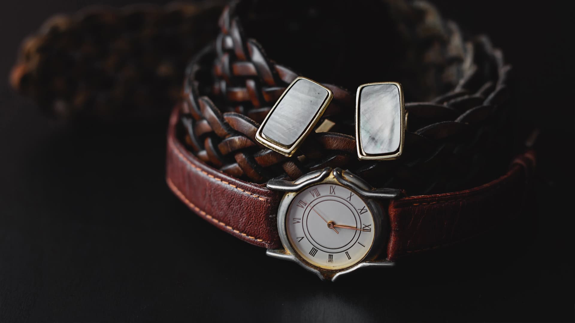 A watch with a red leather brand