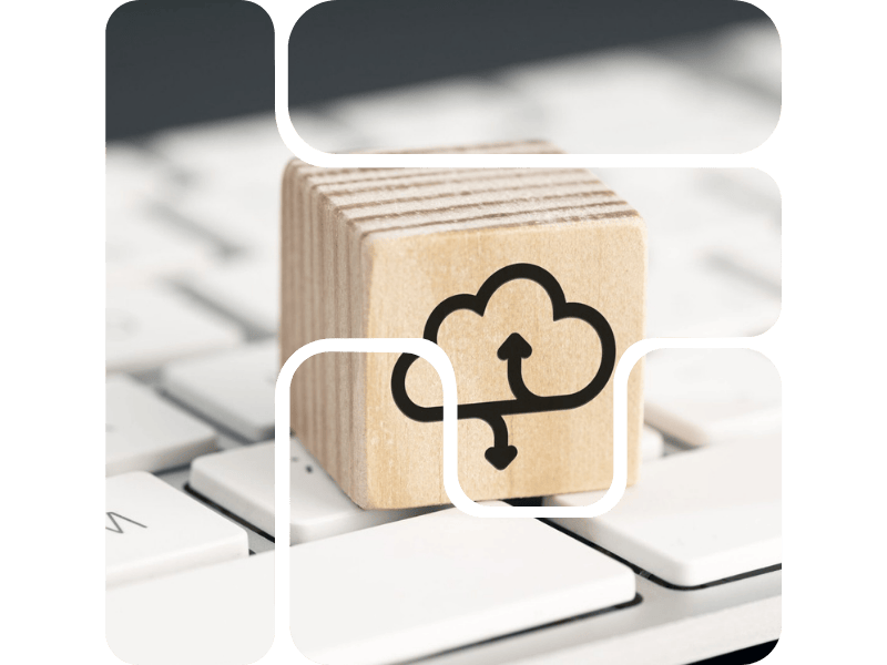 a cloud icon on wood piece on a keyboard