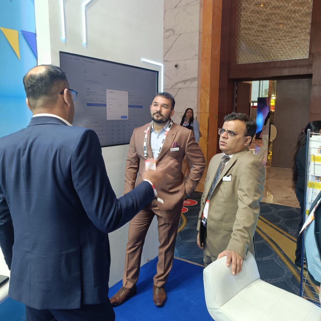 Leaders from Aekyam team interacting with a booth visitor at the PRC