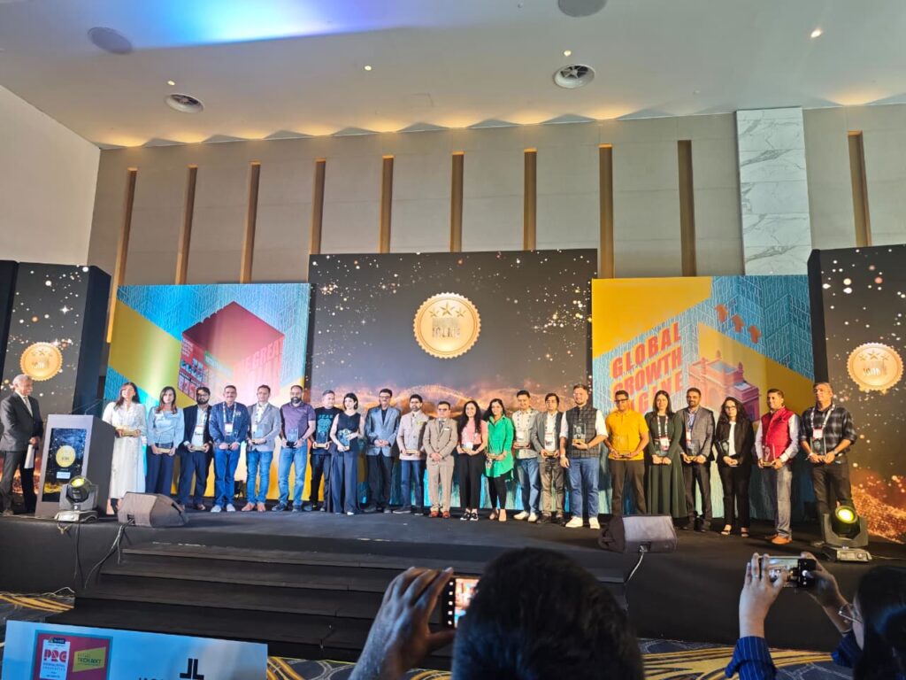 Large group of professionals posing at the PRC stage