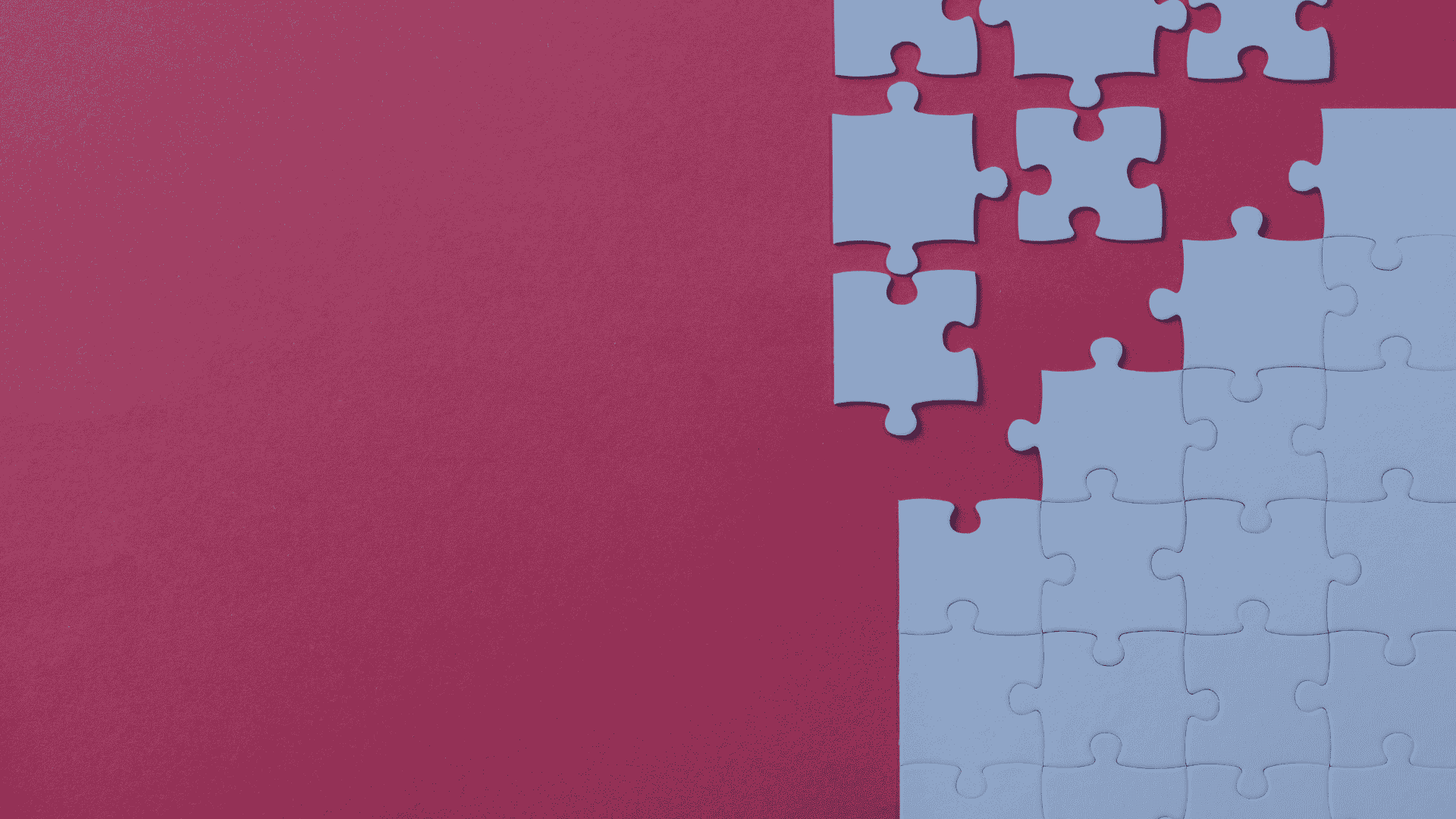 puzzle pieces disintegrated from each other against a red backdrop