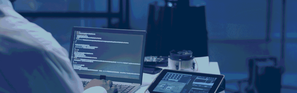 a man working on his laptop with a blurred image of a robot in front of him