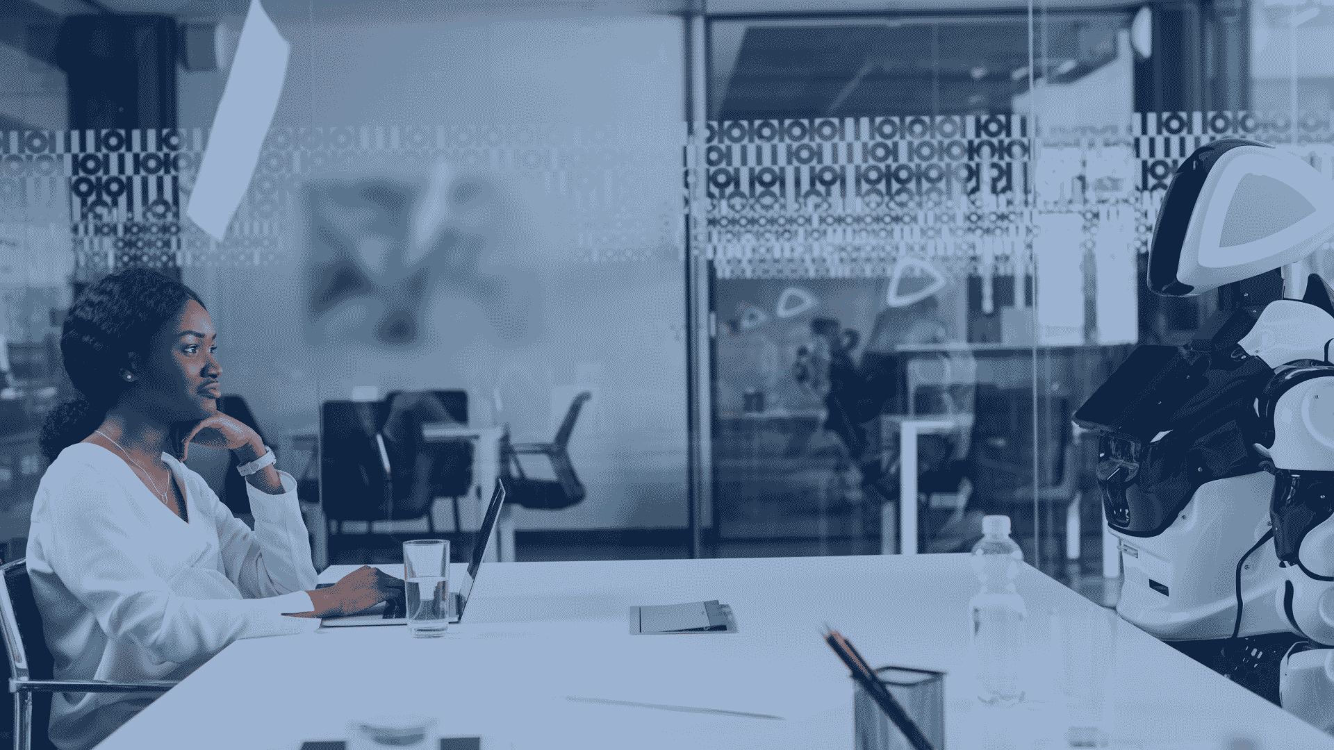 A businesswoman collaborates with a humanoid robot in a sleek, modern office space