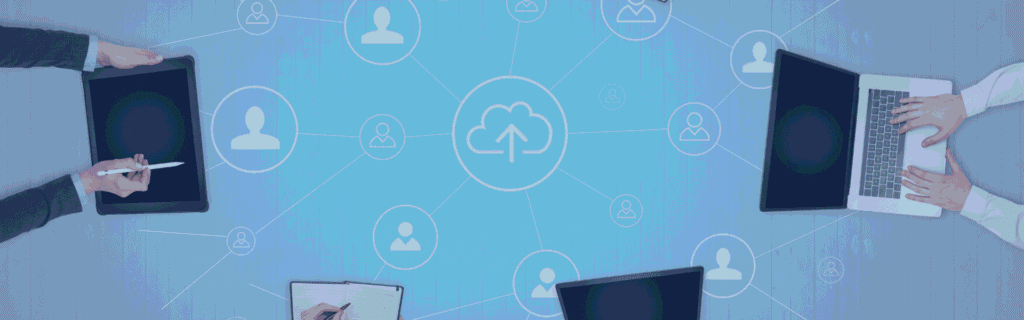 Business professionals using laptops, tablets, and notebooks around a connected cloud network diagram