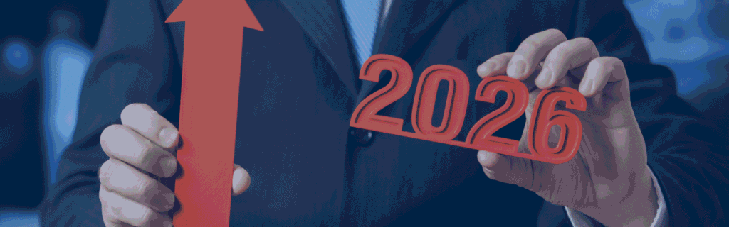 Business professional holding a red upward arrow and the year 2026, symbolizing business growth and progress.